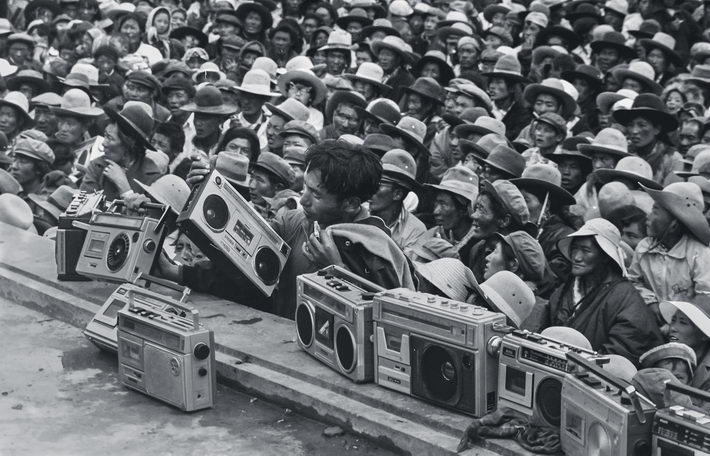 1983: At the Nagqu Horse Racing Festival in Nagqu Prefecture of Tibet Autonomous Region, herders place recorders on the edge of the stage to record a song by folk artists in performance. Portable recorders became popular in the early 1980s.  by Tashi Tseten