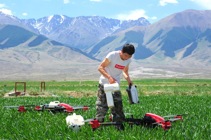 June 11, 2018: A drone operator changes battery and pesticide tank in Hami City of China’s Xinjiang Uygur Autonomous Region. During harvest peak time, drone operators from Heilongjiang Province are often hired to work in other provinces and regions. VCG