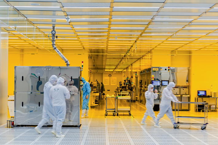 A group of workers from SJsemi, a semiconductor foundry in Jiangyin, check facilities in a wet processing zone.  by Gu Qiang